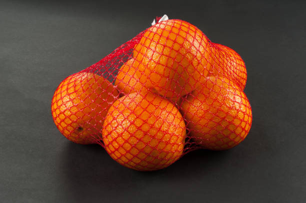 oranges in bag mesh stock photo