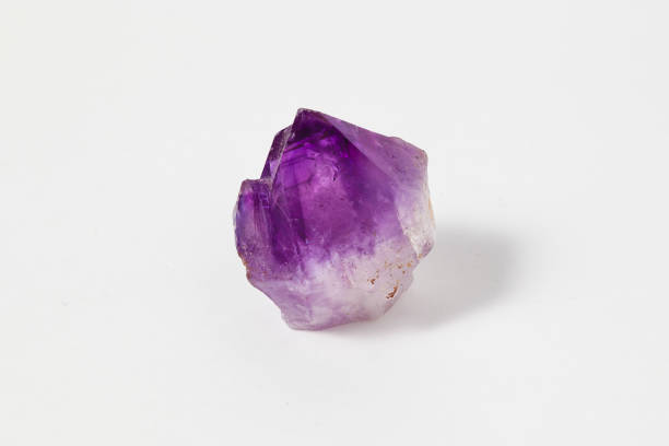 Ore amethyst on white background. Ore amethyst on white background. The ancient Greeks wore amethyst and carved drinking vessels from it in the belief that it would prevent intoxication. amethyst stock pictures, royalty-free photos & images