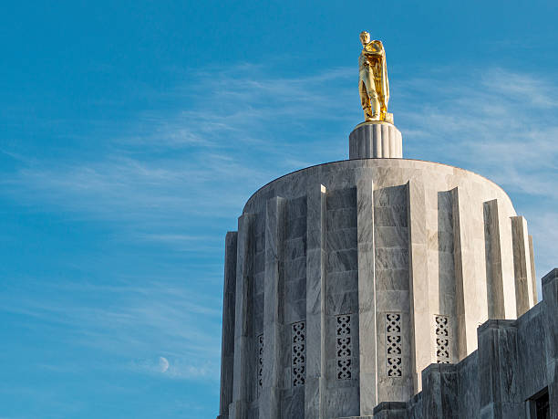Oregon State Capitol Building Pioneer Man Salem Blue Sky The Gold Leaf statue on top of the Oregon State Capitol building. Known as the Oregon Pioneer. oregon state capitol stock pictures, royalty-free photos & images