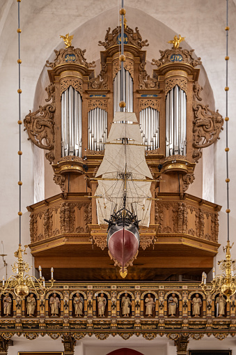 Organ and model of a ship in Sct. Nikolaj Church in Nakskov. The organ dates back to 1648. The core of the church is from prox. 1400 and it has been modernized a number of times since. The tradition with ship models in churches can be seen all over Denmark. Nakskov is the main city on the Danish island Lolland