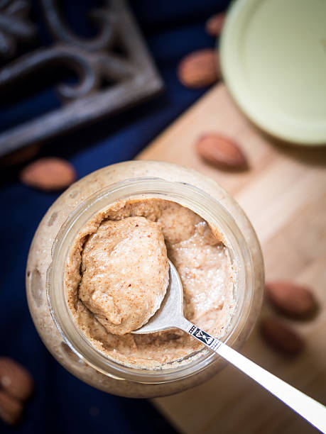 Organic almond butter in a glass jar Homemade almond butter in a jar. almond butter stock pictures, royalty-free photos & images