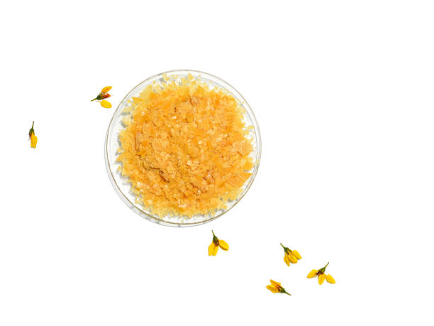 Organic Carnauba Wax comes in the form of hard yellow flakes and is widely used in cosmetics as an emulsifier or as a thickening agent stock photo