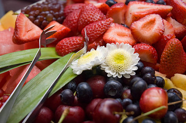 Organic Fruit Plate with Edible Flowers stock photo