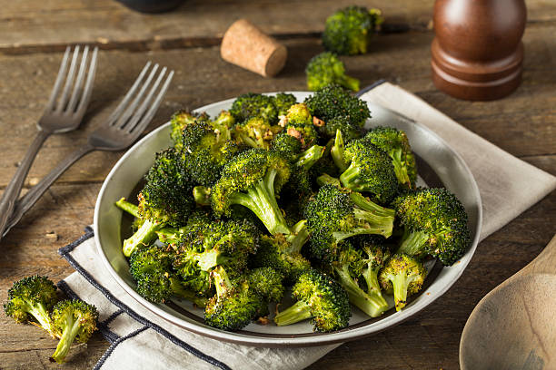 Organic Green Roasted Broccoli Florets Organic Green Roasted Broccoli Florets with Garlic crunchy stock pictures, royalty-free photos & images