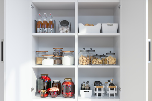Organised Pantry Items With Variety of Nonperishable Food Staples And Preserved Foods in Jars On Kitchen Shelf.