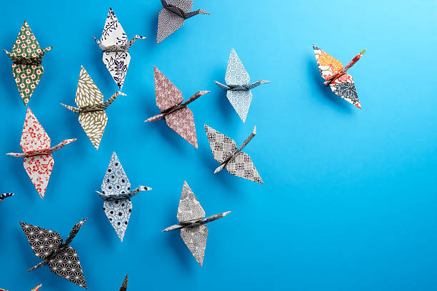Origami birds Colorful origami birds flying to the light. different cultures stock pictures, royalty-free photos & images