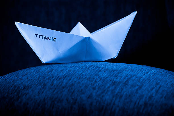 Origami paper ship in blue stock photo
