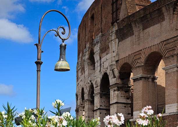 Ornate street lamp with Colosseum in background stock photo