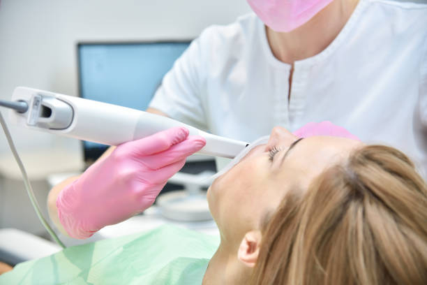 Orthodontist scanning teeth with 3d scanning machine. stock photo