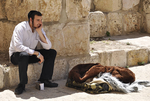 Orthodox jewish man sits on a step in Jerusalem, Israel stock photo
