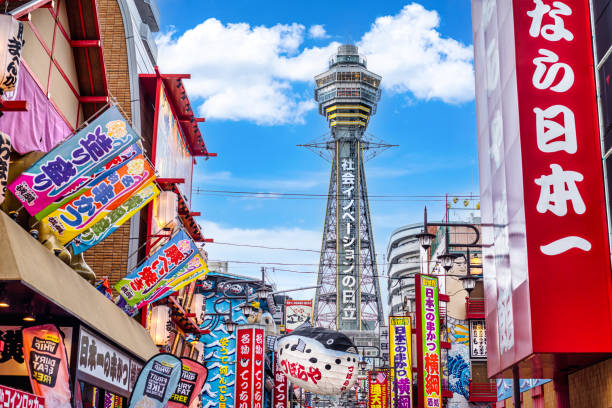 Osaka Tower and view of the neon advertisements in Shinsekai district, Osaka Osaka, Japan - March 28, 2019: Osaka Tower and view of the neon advertisements in Shinsekai district during day, Osaka, Japan japan  tourism stock pictures, royalty-free photos & images
