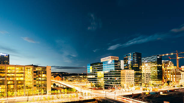 Oslo Norway. Night Panoramic View Of Contemporary District Of Hi Oslo, Norway. The Night Panoramic View Of Contemporary District Of Black And White High-Rised Buildings In The Center Of City In Bright Illumination In Summer Evening, Blue Sky Background, Copyspace. oslo stock pictures, royalty-free photos & images