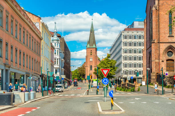 Oslo, Norway: View of St. Olav's Cathedral in the center of Oslo. A street with historical architecture and walking people stock photo