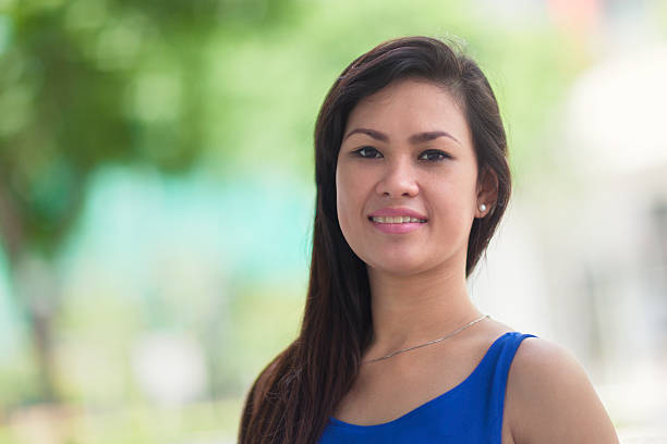 Out in the park Close up portrait of a sporty 30+ woman outdoors in a park. filipino woman stock pictures, royalty-free photos & images