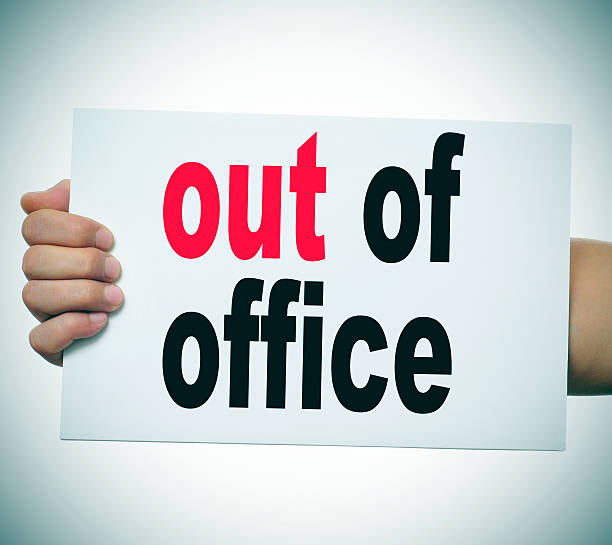 out of office man hand and arm holding a signboard with the text out of office written in it after work stock pictures, royalty-free photos & images