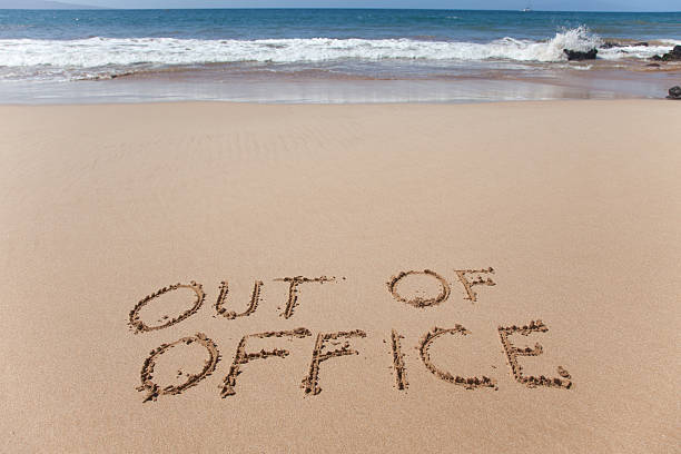 Out of office written in the sand on a beach Out of office. A simple concept image written in the sand on a beautiful Hawaii beach. after work stock pictures, royalty-free photos & images