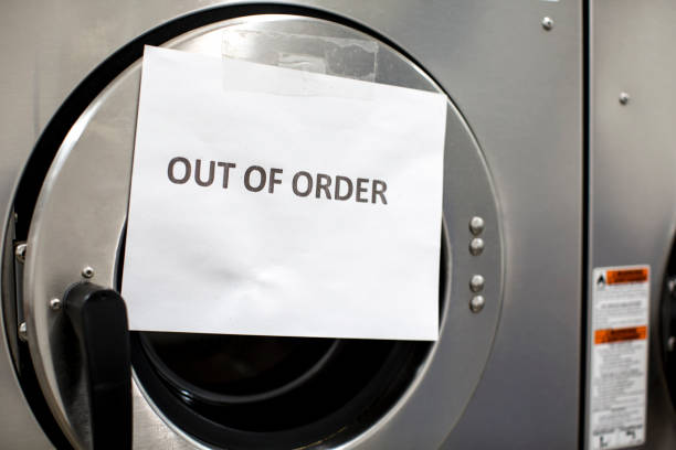 Out of order sign at a washing machine that is not working stock photo