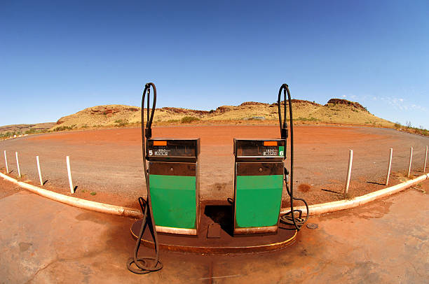 Outback petrol station fuel pumps in remote Western Australia. "A wide angled image of two petrol (gasoline) petrol pumps located in a remote, outback petrol station in Australia." bowser stock pictures, royalty-free photos & images