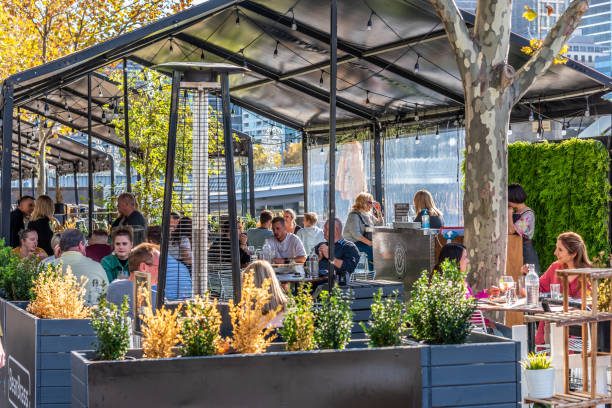 Outdoor al fresco dining restaurants utilise the promenade space along the Yarra river stock photo