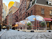 istock Outdoor dining tables in bubbles along Stone Street during the coronavirus pandemic in New York City 1296182629