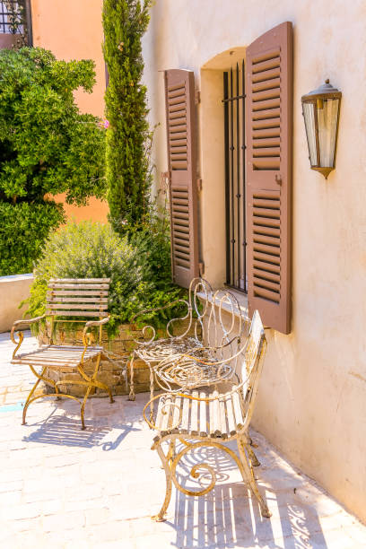 Outdoor furniture in front of shutter window stock photo