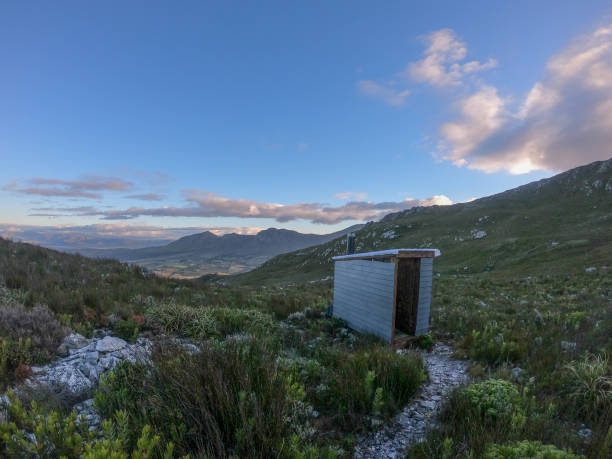 A outdoor longdrop toilet on a mountain. stock photo