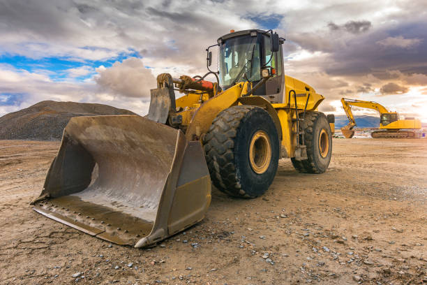 Outdoor quarry with heavy machinery Outdoor quarry with heavy machinery or road construction manufacturing equipment stock pictures, royalty-free photos & images