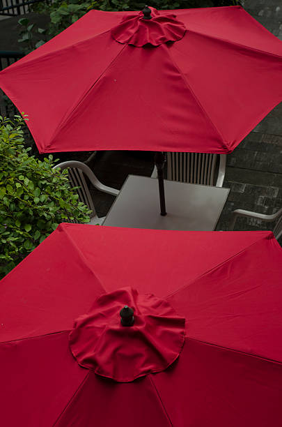 Outdoor Tables with Red Umbrellas stock photo