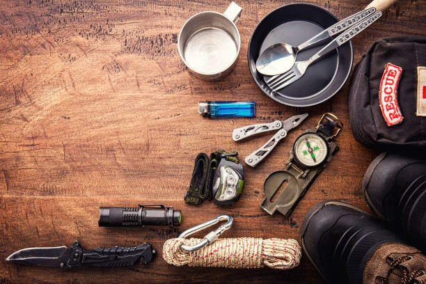 Outdoor travel equipment planning for a mountain trekking camping trip on wooden background Outdoor travel equipment planning for a mountain trekking camping trip on wooden background. Top view - vintage film grain filter effect styles boy scout camp stock pictures, royalty-free photos & images