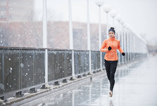 Outrun bad weather Full length shot of a young woman running in the rainhttp://195.154.178.81/DATA/i_collage/pu/shoots/804997.jpg individual event stock pictures, royalty-free photos & images