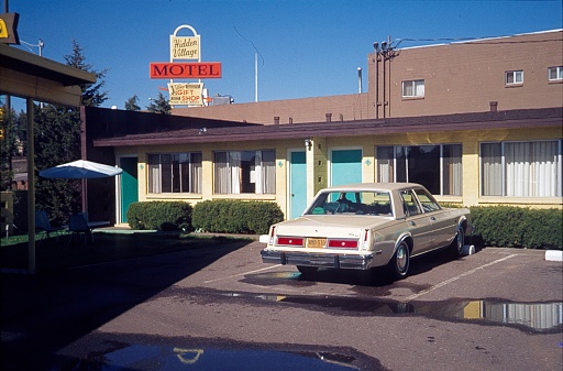 California, USA, 1981. Outside a motel on the west coast of the USA. Also: building and a parked vehicle.