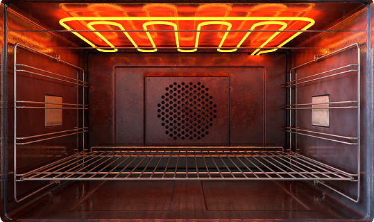 An upclose view through the front of the inside of an empty hot operational household oven with a glowing element and metal rack - 3D render