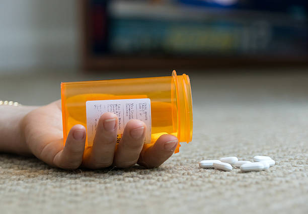 Overdose woman lying on the floor unconscious  after taking prescription drugs xanax pills stock pictures, royalty-free photos & images