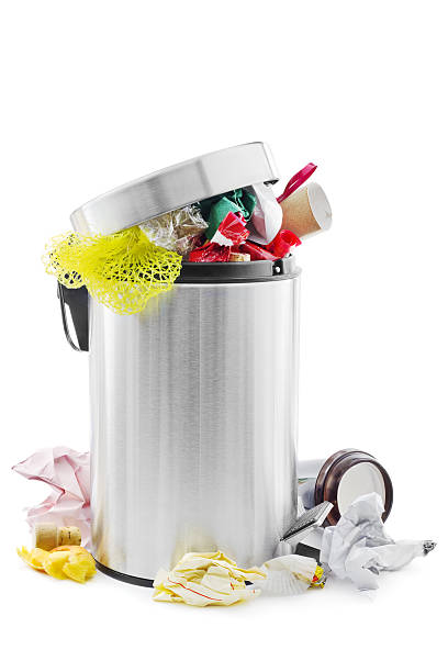 Overflowing stainless steel trash can stock photo