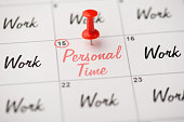 istock Overhead photo of label date 15 with inscriptions personal time and work with red pin isolated on the calendar background 1348657852