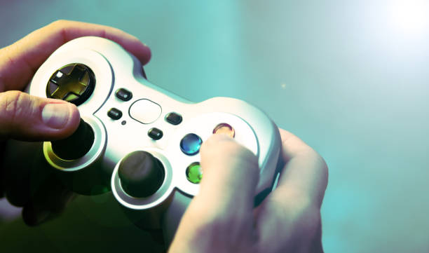 Overhead shot of a man's hands holding a video game controller. stock photo