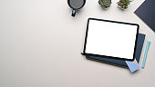 istock Overhead shot of mock up digital tablet with empty screen on whitetable. Blank screen for text message or information content. 1298092934