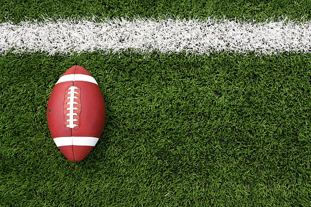 Overhead view of a football lying on a football field American Football on the Field with room for copy football field stock pictures, royalty-free photos & images