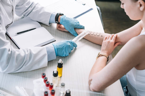 overhead view of allergist holding ruler near marked hand of woman overhead view of allergist holding ruler near marked hand of woman allergy test stock pictures, royalty-free photos & images