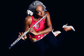 An overhead view of a beautiful African American woman playing her flute.