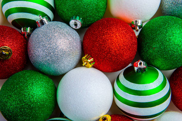 Overhead view of Red, Green, White shiny glowing Christmas balls. Xmas glass ball. Holiday decoration background stock photo