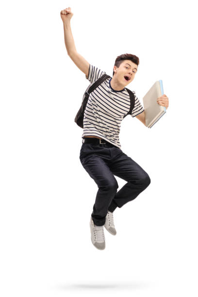 Overjoyed teenage student jumping and gesturing happiness Overjoyed teenage student jumping and gesturing happiness isolated on white background boy jumping stock pictures, royalty-free photos & images
