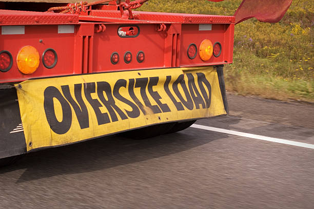 Oversize Load Oversize sign truck on a highway oversized object stock pictures, royalty-free photos & images