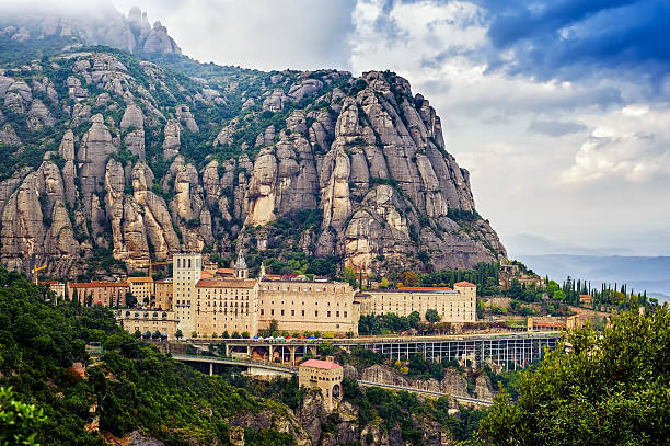 Overview Montserrat monastery Santa Maria de Montserrat monastery. Monastery on mountain near Barcelona, in Catalonia abbey monastery stock pictures, royalty-free photos & images