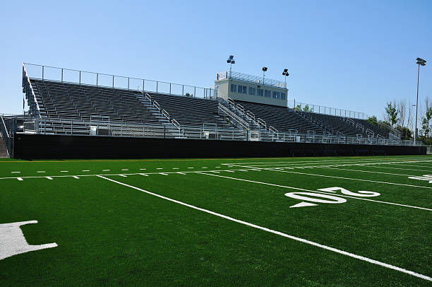 Overview of empty American high school football stadium stock photo