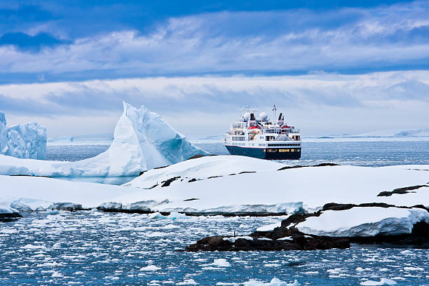 Overview of large cruise ship sailing through icy waters Big cruise ship in the Antarctic watersBig cruise ship in the Antarctic watersBig cruise ship in Antarctic waters cruise vacation stock pictures, royalty-free photos & images