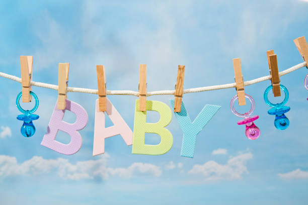 Pacifiers and BABY Letters Hanging On A Clothesline stock photo