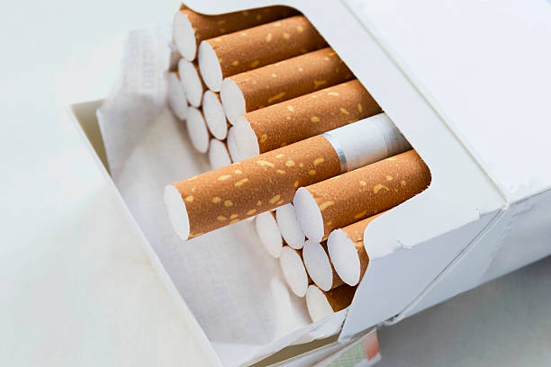 Pack of cigarettes Opened pack full of cigarettes closeup cigarette stock pictures, royalty-free photos & images