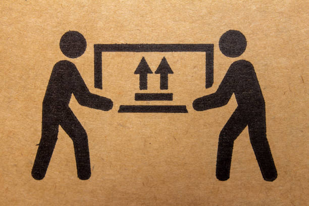 Packaging symbol to indicate heaviness and needs two people to lift Packaging symbol to indicate heaviness and needs two people to lift picking up stock pictures, royalty-free photos & images