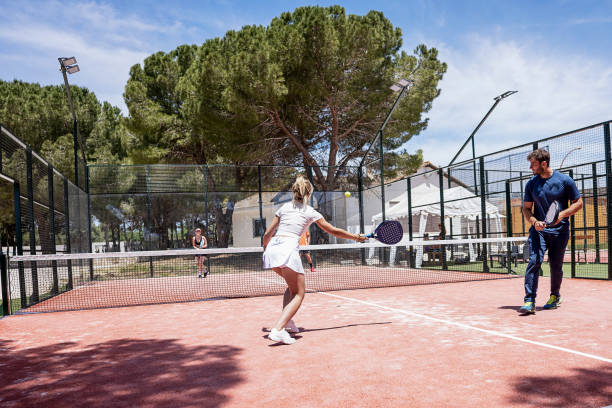 padel tennis players play on an outdoor court stock photo